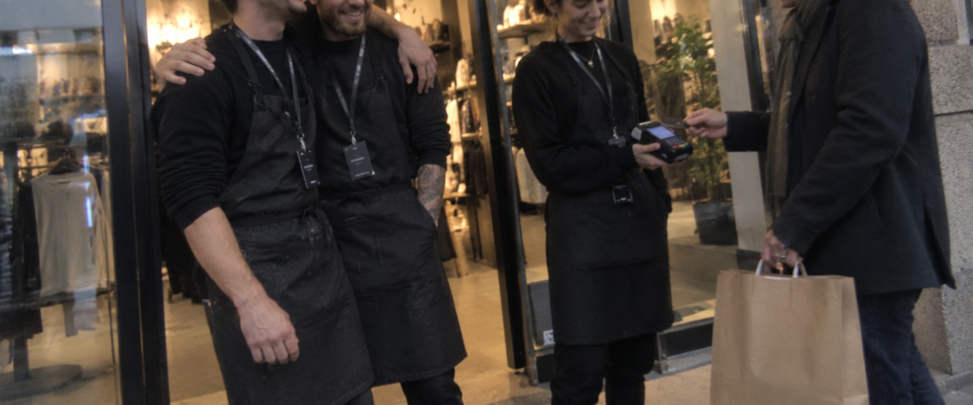 A customer completing a purchase with a shop team at their doorway
